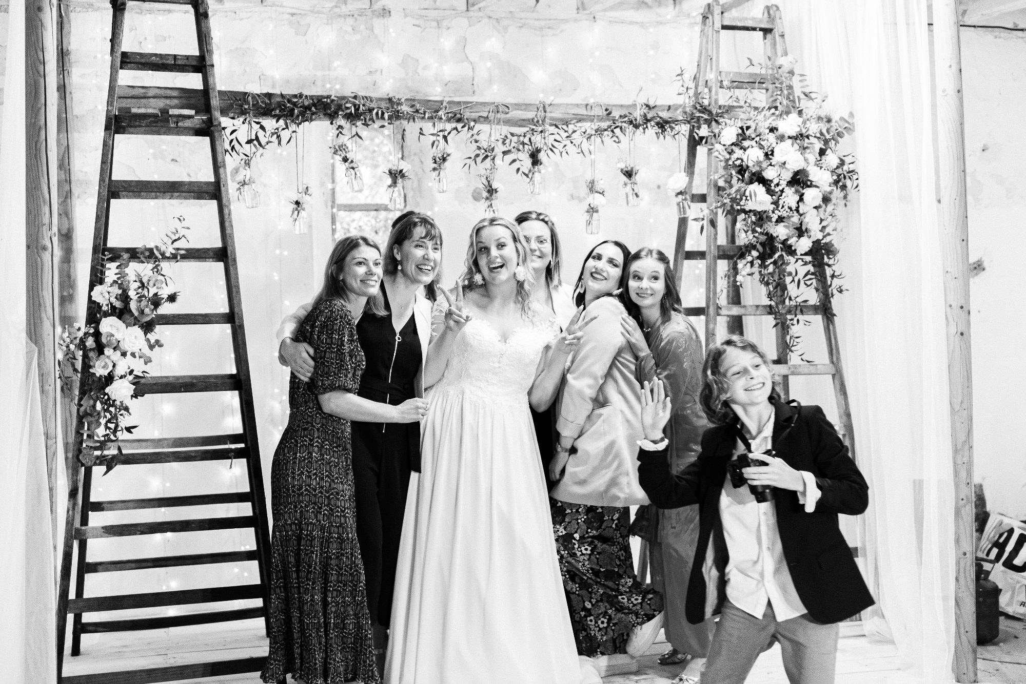 La mariée et ses amies devant l'arche de la chapelle laïque